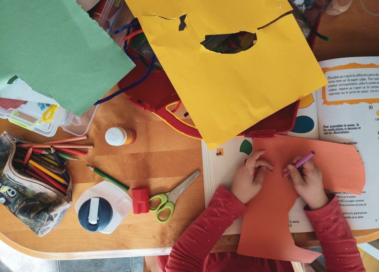 Children Cutting out paper and creating artworks and collages